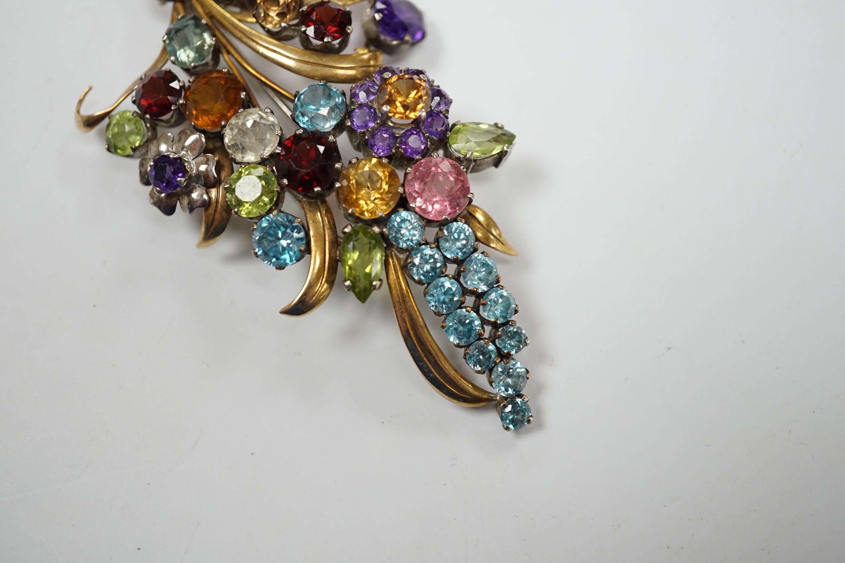 A 9ct and multi gem set floral spray brooch, including zircons, tourmaline and amethyst, by Cropp & Farr, 85mm gross weight 23.1 grams